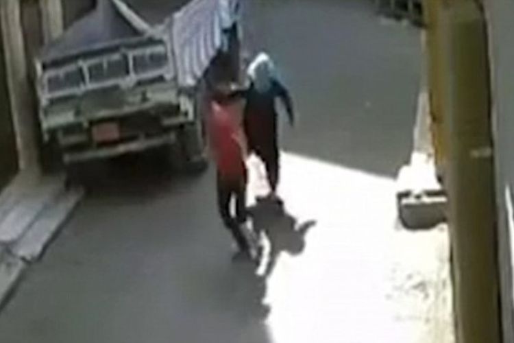 Dalam foto yang diambil dari layar video ini memperlihatkan seorang perempuan bernama Rania mengejar pria yang melecehkannya di jalanan kota Qena, Mesir.