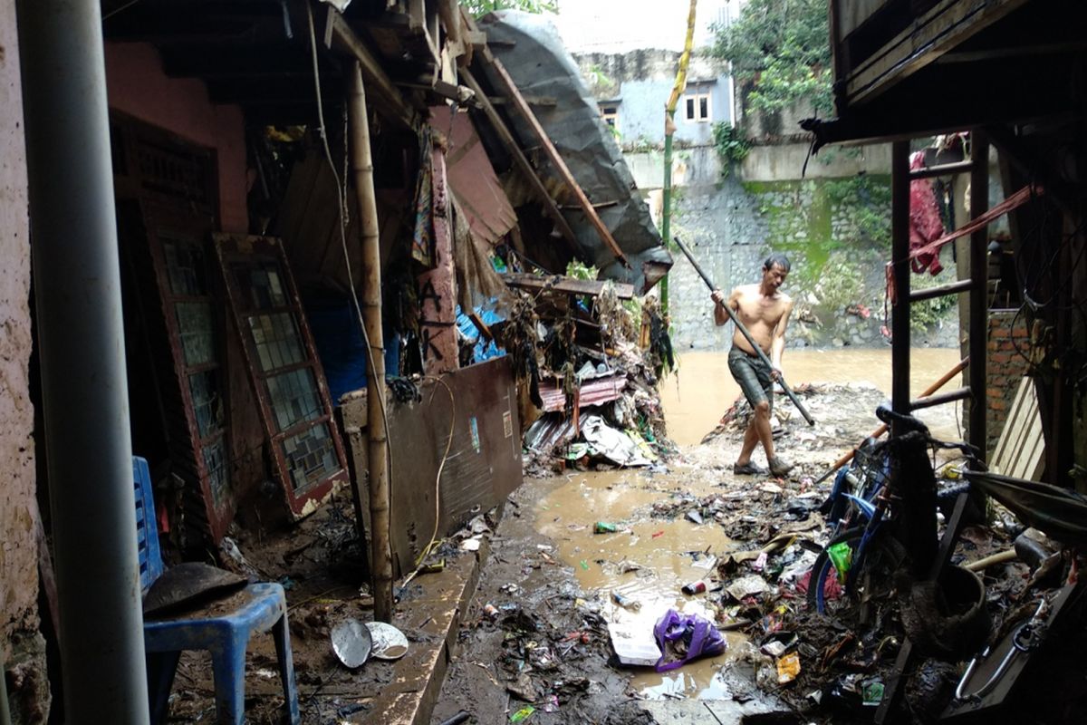 Warga Bidaracina membersihkan sisa-sisa banjir yang melanda wilayahnya Jumat (9/2/2018). Banjir beberapa hari lalu membuat kawasan ini terendam air dan membawa banyak lumpur