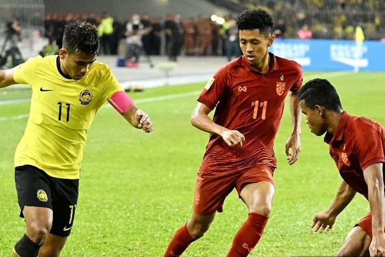 Pemain Malaysia Safawi Rasid (kiri) memperebutkan bola dengan pemain Thailand Bordin Phala (tengah) dan Sasalak Haiprakhon (kanan) pada semifinal Piala AFF 2022 antara Malaysia vs Thailand di Stadion Nasional Bukit Jalil di Kuala Lumpur pada Sabtu 7 Januari , 2023.