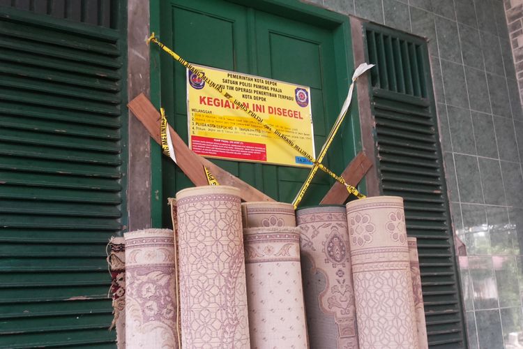 Papan segel yang dipasang di pintu masuk Masjid Al Hidayah di Jalan Muchtar Raya, Sawangan, Depok, Senin (5/6/2017). Masjid Al Hidayah adalah masjid yang menjadi pusat kegiatan jemaah Ahmadiyah di Kota Depok. Untuk kesekian kalinya, masjid ini disegel oleh Pemerintah Kota Depok.