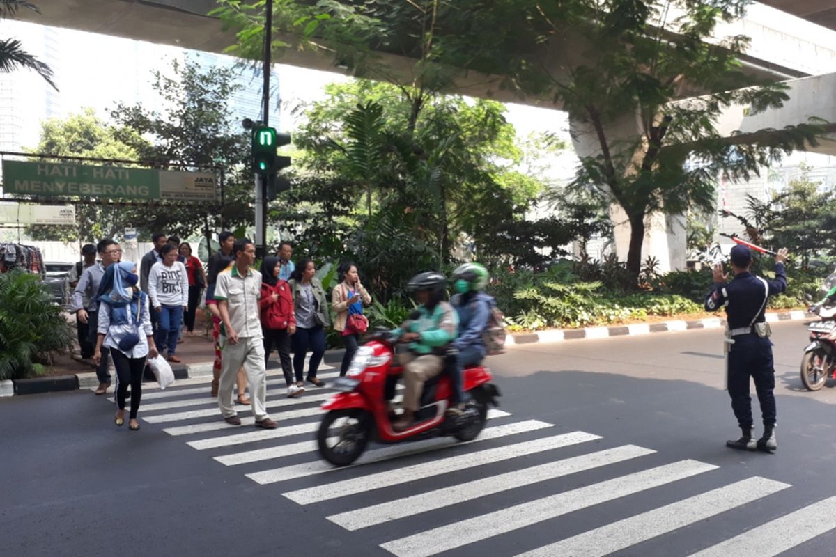 Tampak pengendara motor menerobos pelican crossing di depan Mall Ambassador, Kuningan, Jakarta Selatan, Kamis (26/07/2018).