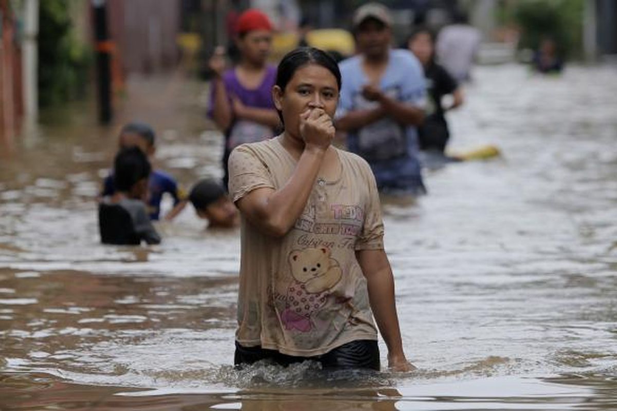 Warga berjalan menembus banjir di Kelurahan Cipinang Melayu, Kecamatan Makasar, Jakarta Timur, Senin (20/2/2017). Banjir kerap terjadi menyusul meluapnya Kali Sunter yang melintasi Cipinang Melayu, ditambah, curah hujan yang tinggi sepanjang hari kemarin.