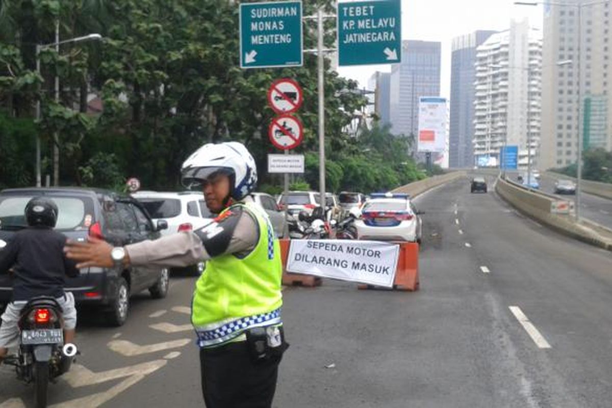 Petugas polisi lalu lintas mengatur jalan raya