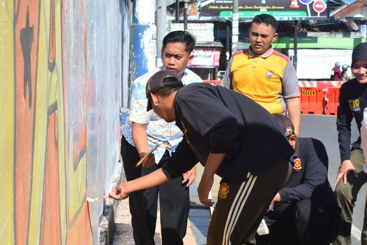 Sejumlah elemen masyarakat sipil bersama polisi di Kota Tegal, Jawa Tengah bergotong royong melakukan pengecetan ruang publik di titik strategis yang dicoret-coret akibat tindakan vandalisme, Jumat (12/9/2025).