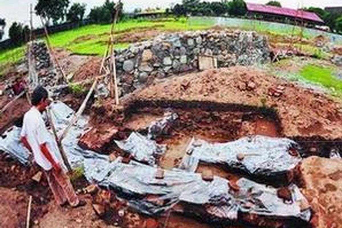 Kondisi situs purbakala berupa sisa-sisa fondasi dari bata merah, konstruksi sumur kuno dan terakota dari bekas ibu kota Majapahit rusak karena penggalian tanah untuk pembuatan fondasi beton dan tembok proyek pembangunan Pusat Informasi Majapahit di Kompleks Museum Trowulan, Mojokerto, Jawa Timur, Senin (29/12). Bangunan di latar belakang adalah gedung museum purbakala yang ada saat ini.