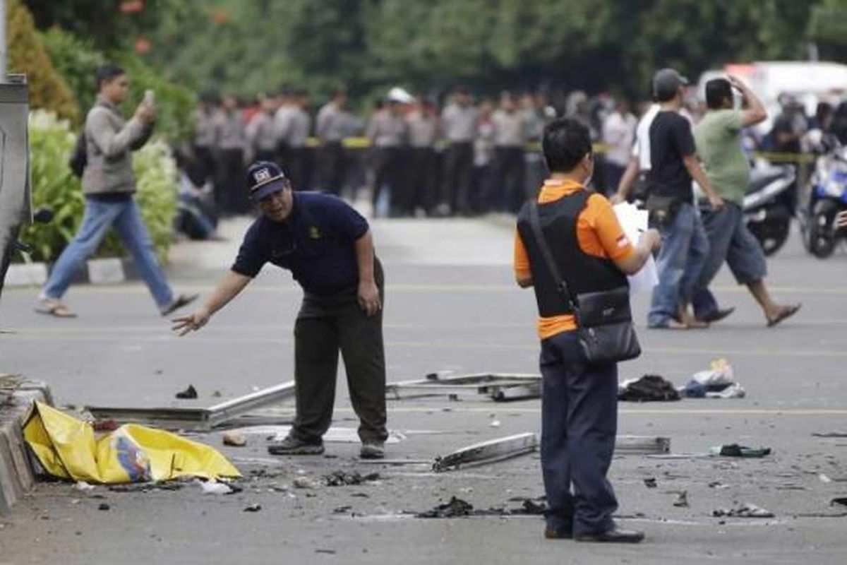 Polisi memeriksa puing-puing di lokasi setelah ledakan menghantam kawasan Jalan MH Thamrin, Jakarta Pusat, 14 Januari 2016. Serangkaian ledakan menewaskan sejumlah orang, terjadi baku tembak antara polisi dan beberapa orang yang diduga pelaku.