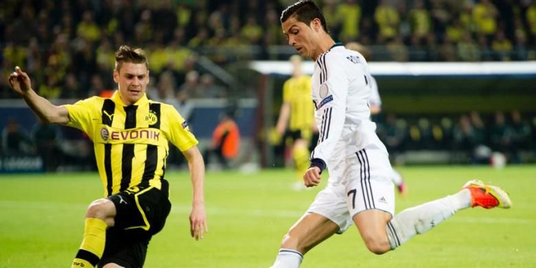 Bek Borussia Dortmund, Lukasz Piszczek (kiri), menghadang gelandang Real Madrid, Cristiano Ronaldo, pada leg pertama semifinal Liga Champions, di Signal Iduna Park, Rabu (24/4/2013). 