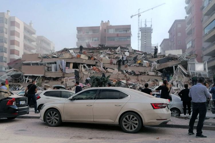 A collapsed building in Izmir, Turkey, Friday, Oct. 30, 2020, after a strong earthquake in the Aegean Sea has shaken Turkey and Greece. Turkeys Disaster and Emergency Management Presidency said Fridays earthquake was centered in the Aegean at a depth of 16.5 kilometers (10.3 miles) and registered at a 6.6 magnitude.(DHA via AP)