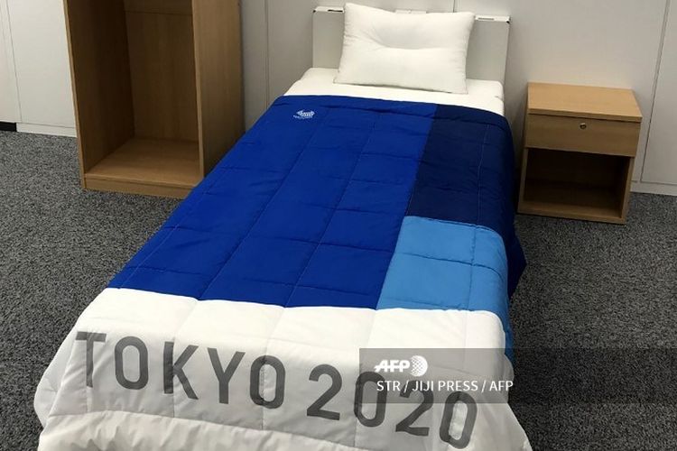 In this picture taken on January 9, 2020 a set of bedroom furniture, including a bed made of cardboards for the Tokyo 2020 Olympic and Paralympic Village is displayed in Tokyo. - Randy athletes worried that eco-friendly cardboard beds could curtail their sex life at this summers Tokyo Olympics can breathe easy -- theyre sturdy enough, say manufacturers. (Photo by STR / JIJI PRESS / AFP) / Japan OUT