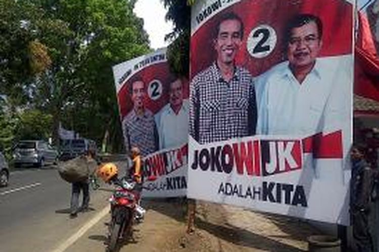 Anggota Panwas Kabupaten Malang, Jawa Timur, saat menurunkan paksa baliho raksasa milik pasangan capres-cawapres Jokowi-JK, Senin (7/7/2014).