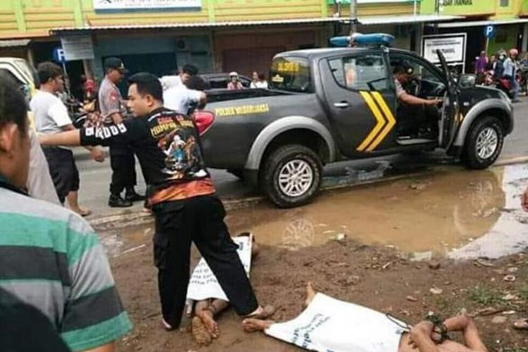 Polisi mengeluarkan dua orang lelaki yang dipergoki  dalam kondisi telanjang di jok tengah mobil Suzuki Ertiga bernopol B 2254 KFB yang terpakir di depan pasar Trangkil, Kabupaten Pati, ?Kamis (20/12/2018) siang.?