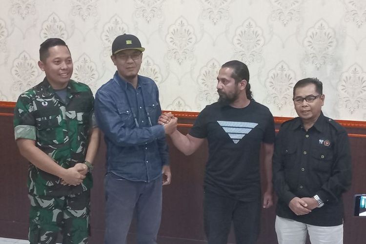 Komandan Kodim 0304 Agam Letkol Czi Renggo Yudi (kiri) bersama wartawan dan anggota TNI yang sempat bertikai di lapangan saat liputan. Renggo menyampaikan permintaan maaf kepada wartawan dan tetap memproses secara hukum militer kepada anggotanya. 