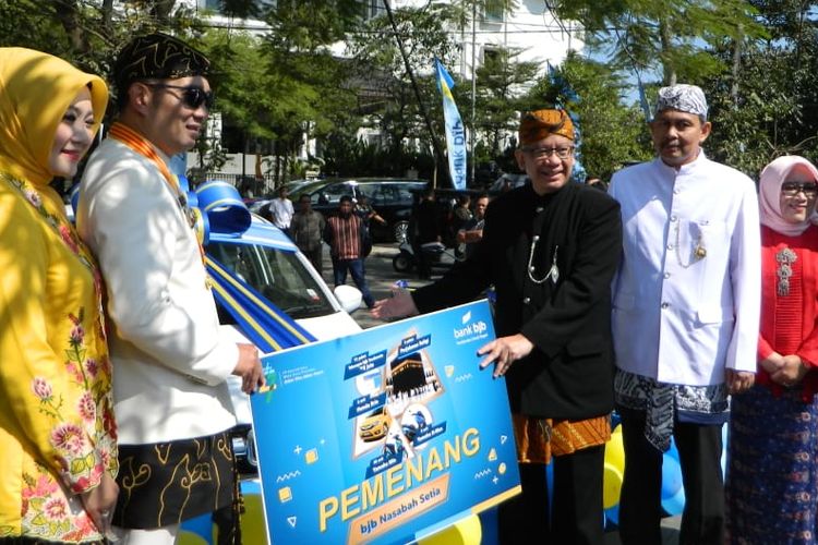 Gubernur Jawa Barat Ridwan Kamil saat menyerahkan hadiah bagi ASN Pemprov Jabar dalam rangkaian HUT ke-74 Jabar di Lapangan Gasibu, Jalan Diponegoro, Senin (19/8/2019).