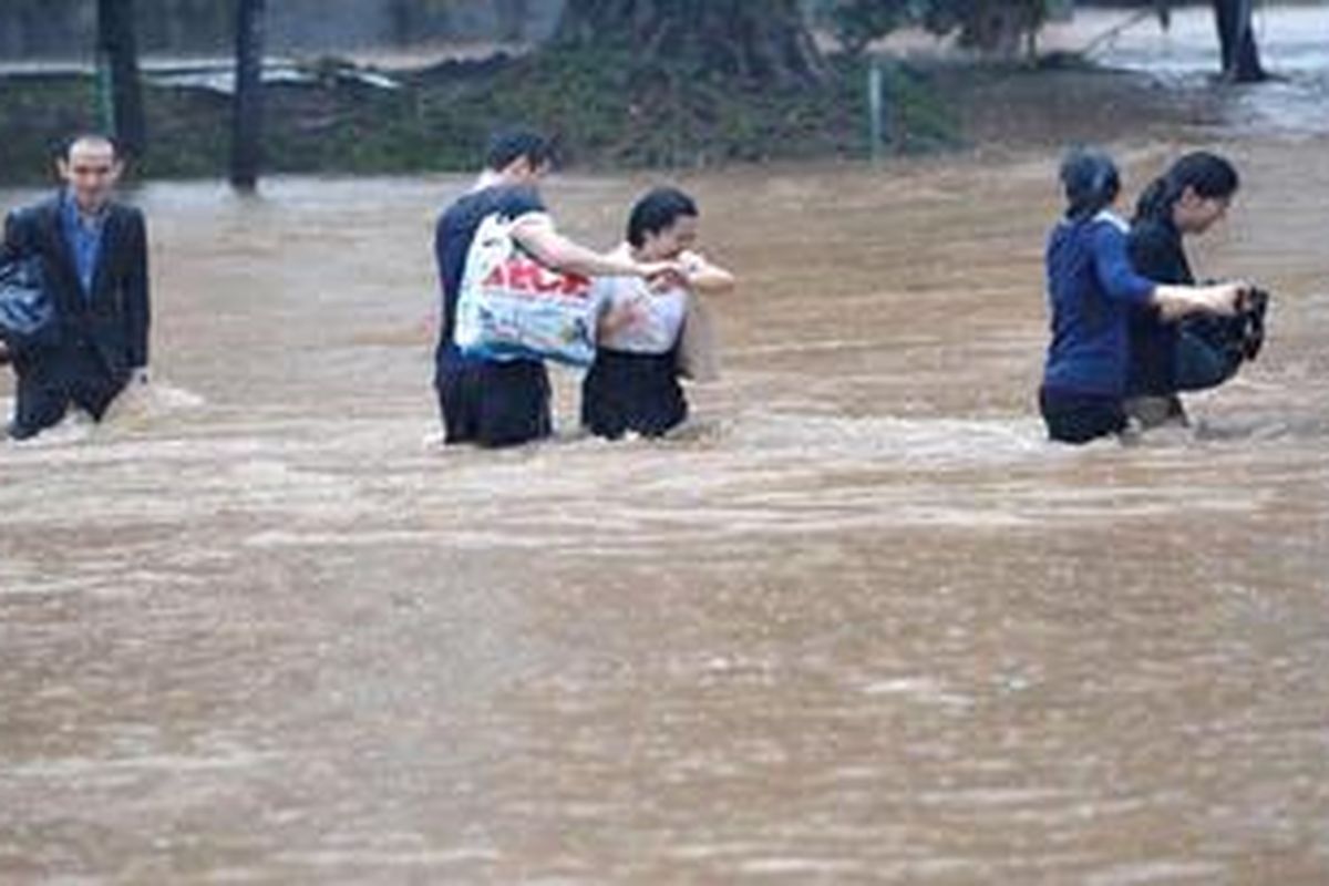Warga menerobos banjir yang menerjang kawasan Jalan MH Thamrin, Jakarta, Kamis (17/1/2013).  