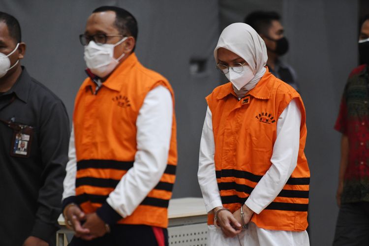 Bupati Probolinggo Puput Tantriana Sari (kanan) bersama suaminya yang juga anggota DPR dan mantan Bupati Probolinggo Hasan Aminuddin mengenakan rompi tahanan KPK usai diperiksa di gedung KPK, Jakarta, Selasa (31/8/2021) dini hari. KPK melakukan operasi tangkap tangan terhadap Bupati Probolinggo Puput Tantriana Sari dan suaminya Hasan Aminuddin serta mengamankan barang bukti Rp326.500.000 dan menahan keduanya sebagai tersangka kasus dugaan penerimaan suap terkait seleksi kepala desa di Kabupaten Probolinggo. ANTARA FOTO/Hafidz Mubarak A/wsj.