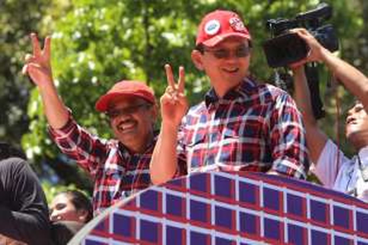 Pasangan cagub-cawagub nomor urut 2, Basuki Tjahaja Purnama-Djarot Saiful Hidayat, berdiri di atas kendaraan saat konvoi mendeklarasikan kampanye damai di kawasan Monas, Jakarta Pusat, Sabtu (29/10/2016). Acara ini diisi dengan penandatangan prasasti damai dan arak-arakan kendaraan hias.