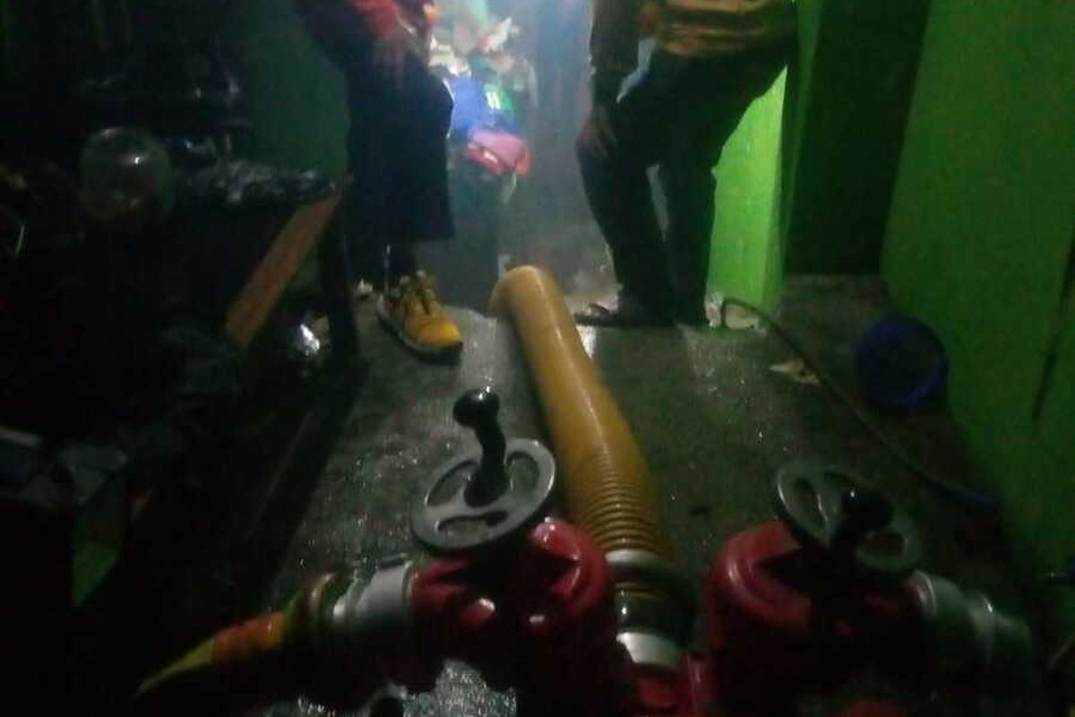 Petugas diskar PB tengah melakukan pengedotan air di salah satu rumah yang terendam.
