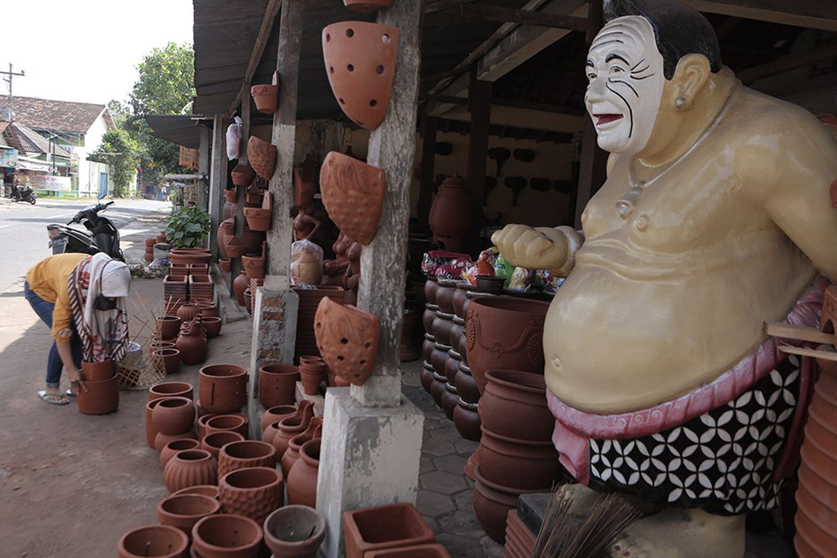 A file photo of a crafter wrapping some of the pots in her shop in Yogyakarta in Central Java dated July 22, 2020. 