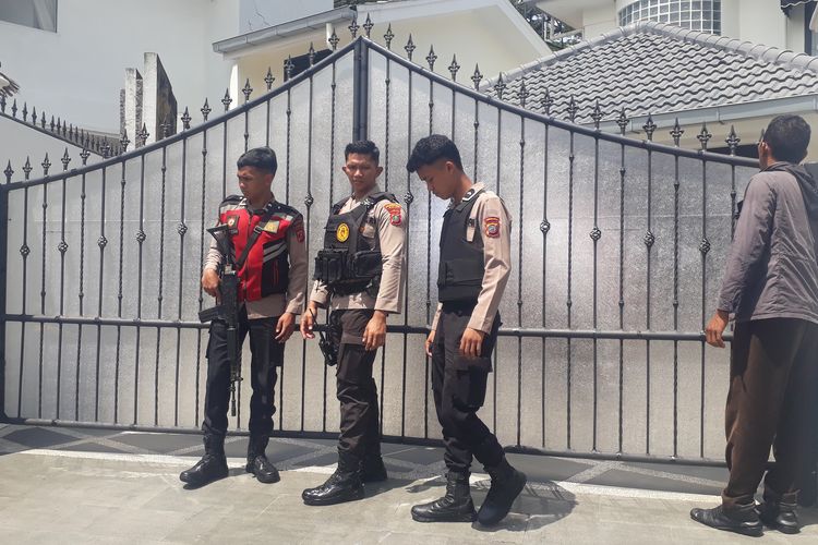 Penyidik Komisi Pemberantasan Korupsi menggeledah rumah Kadis PUPR Sumut nonaktif, Topan Ginting di Cluster Topaz, Komplek Royal Sumatera, Kota Medan, Rabu (2/7/2025) siang. Tampak petugas Kepolisian membantu berjaga di depan pintu masuk rumah Topan. 