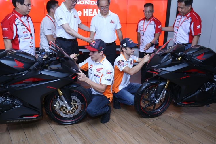 Pebalap Repsol Honda Team, Marc Marquez (kanan bawah) dan Dani Pedrosa (kiri bawah) saat membuat tanda tangan motor honda di Astra Biz Center, BSD, Tangerang, Selasa (17/10/2017). Pebalap tim Repsol Honda ini menyebarkan virus keselamatan berkendara kepada generasi muda di Tanah Air melalui kampanye #cari_aman yang diadakan PT Astra Honda Motor.