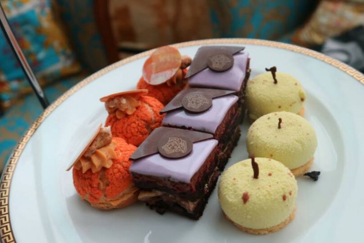 Camilan menemani High Tea di Palazzo Versace Gold Coast. Di bagian tengah kue cokelat bergambar Medusa, lambang dari rumah mode Versace.