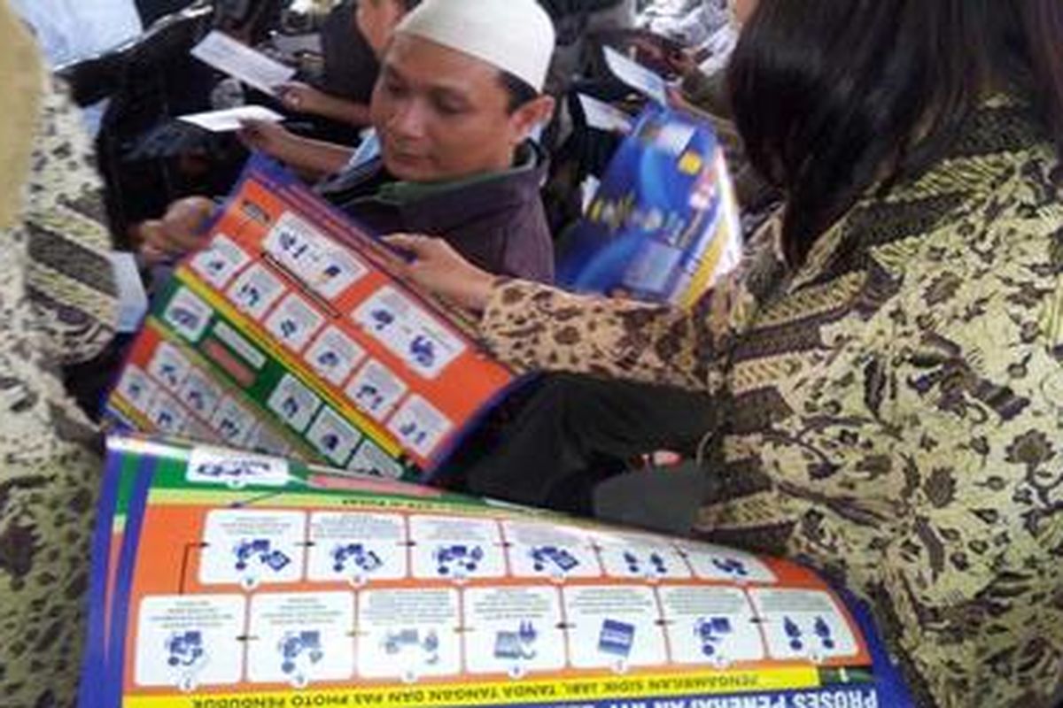 Spanduk sosialisasi e-KTP dibagikan dalam acara sosialisasi e-KTP di Bandung, Senin (16/4/2012).