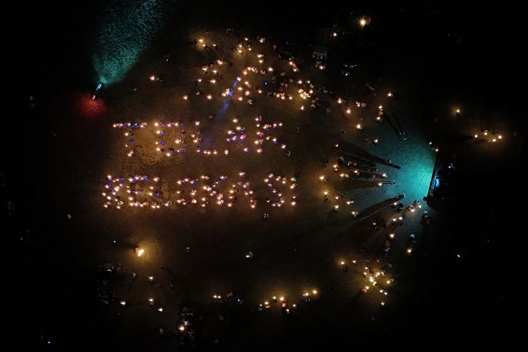 Ratusan masyarakat Pulau Rempang membentuk tulisan tolak relokasi dengan memanfaatkan cahaya dari obor