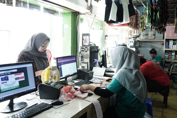 Karyawan Toko Atet melayani pelanggan.