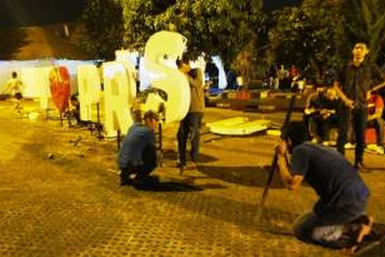 Pekerja memasang neon PRSU (Pekan Raya Sumatera Utara), sementara pembukaan resmi sudah berlangsung. PRSU atau Medan Fair di Jalan Gatot Subroto Medan. 