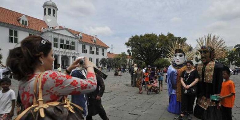 Kelompok kesenian ondel-ondel Bintang Saroja asal Rawamangun tampil menghibur wisatawan sekaligus mengamen di kawasan wisata kota tua di depan Museum Fatahillah, Jakarta, Minggu (27/3/2011).
