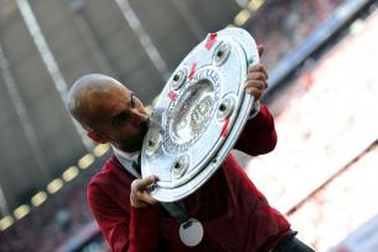 Pelatih Bayern Muenchen, Pep Guardiola, saat mengangkat trofi Bundesliga di Stadion Allianz Arena, Sabtu (10/5/2014). 