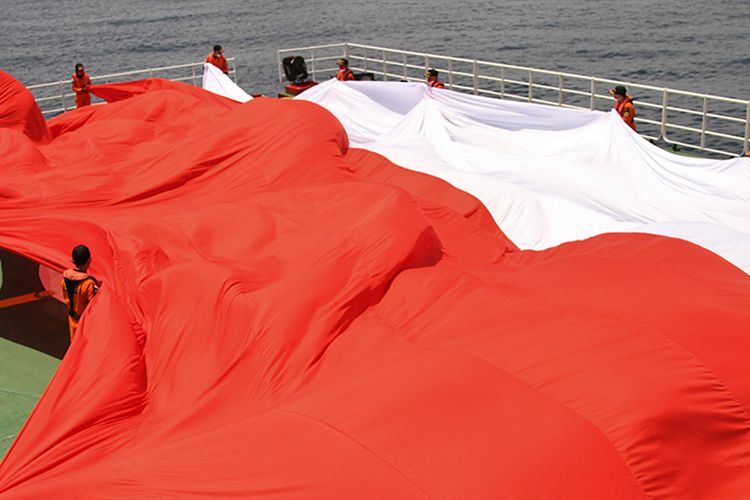 Sejumlah personel Basarnas Kendari membentangkan bendera merah putih raksasa di atas KN SAR Pacitan di sekitar Pulau Hari, Kabupaten Konawe, Sulawesi Tenggara, Sabtu (8/8/2020). Aksi pembentangan bendera merah putih berukuran 25x17 meter itu untuk menyambut hari ulang tahun (HUT) Ke-75 RI.