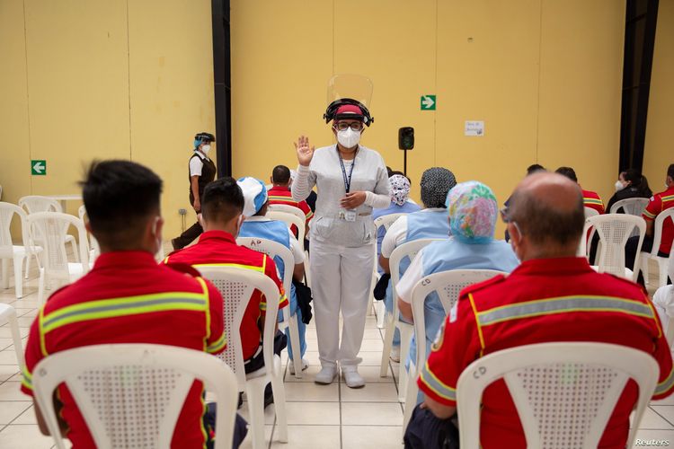 Health workers and fireman sit under observation after receiving doses of the Oxford-AstraZeneca coronavirus vaccine, in Guatemala City, Guatemala, March 10, 2021
