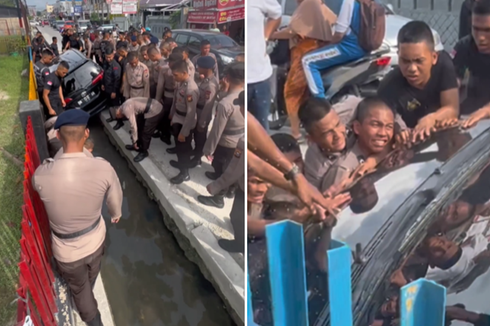 Viral, Video Puluhan Anggota Brimob Gotong Royong Evakuasi Mobil yang Masuk Parit, Polisi: Setirnya Rusak