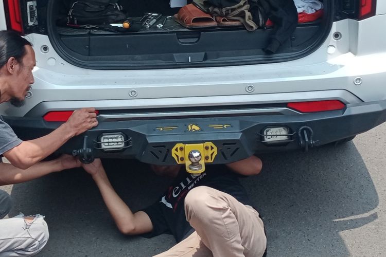 Pihak bengkel mencopot aksesoris lampu belakang di mobil Pajero Sport berwarna putih dengan nomor polisi N 1293 XG di Mapolresta Malang Kota pada Senin (18/11/2024).