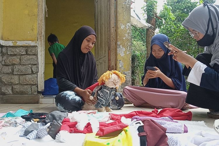 Fredi tampak menjahit busana untuk kucing di kediamannya, Desa Jampang, Kecamatan Kemang, Kabupaten Bogor, Jawa Barat, Jumat (4/12/2020).