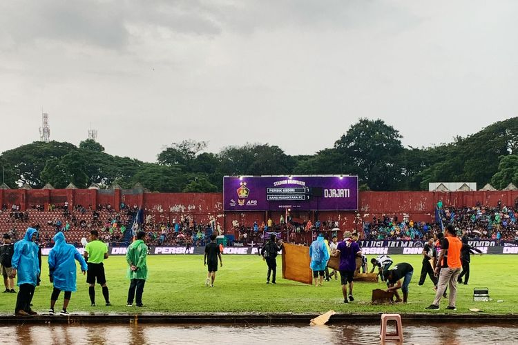 Suporter Persik bergotong royong membantu petugas menghilangkan genangan air dalam laga pekan ke-28 Liga 1 2023-2024 antara Persik vs RANS Nusantara FC, di Stadion Brawijaya, Kediri, Jumat (8/3/2024).