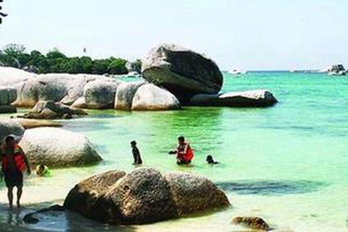 Sejumlah wisatawan menikmati formasi batu granit di atas hamparan pasir putih di Pulau Babi, Kabupaten Belitung, Provinsi Bangka Belitung. Batu granit ini menjadi salah satu daya tarik yang menyedot wisatawan domestik dan mancanegara mengunjungi Pulau Belitong dan pulau-pulau kecil di sekitarnya. 