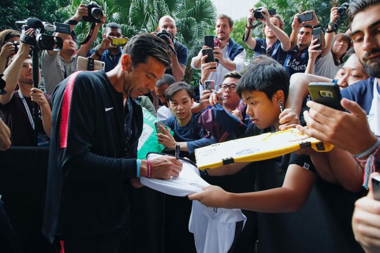 Kiper Paris Saint-Germain, Gianluigi Buffon, melayani permintaan tanda tangan dari fans saat timnya tampil di International Champions Cup di Singapura