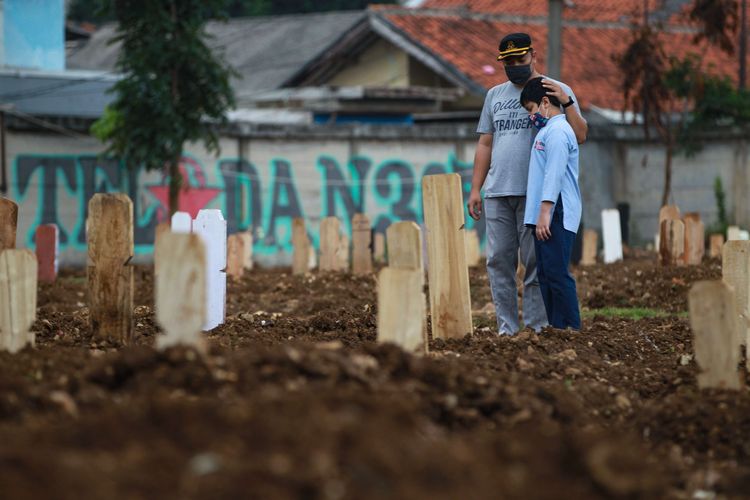 Warga melawat ke makam keluarga yang meninggal akibat Covid-19 di TPU Srengseng Sawah, Jakarta Selatan, Senin (25/1/2021). Berdasarkan data Satgas Penanganan Covid-19, terdapat 9.994 kasus baru dalam 24 jam terakhir. Jumlah pasien Covid-19 di Indonesia hingga hari ini 999.256 orang, terhitung sejak pengumuman pasien pertama pada 2 Maret 2020.