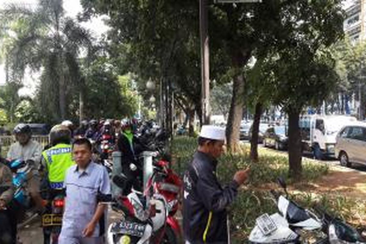 Sepeda motor melintas di atas trotoar saat massa Gerakan Masyarakat Jakarta berunjuk rasa di depan Gedung DPRD DKI Jakarta, Jalan Kebon Sirih, Senin (1/6/2015).