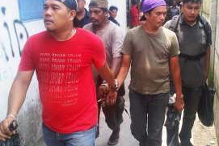 Petugas Sat Reskrim Polresta Medan menggiring seorang pria yang diduga memiliki narkoba saat penggerebekan di Jalan Mangkubumi Medan