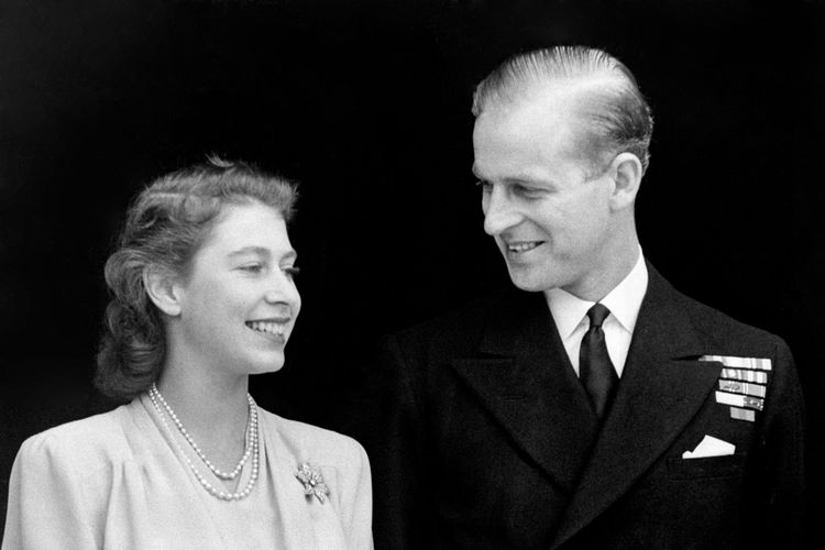 Smiling happily the Princess and her fiance, Lieut. Philip Mountbatten are pictured at Buckingham Palace. Princess Elizabeth's engagement ring is plainly visible in the picture