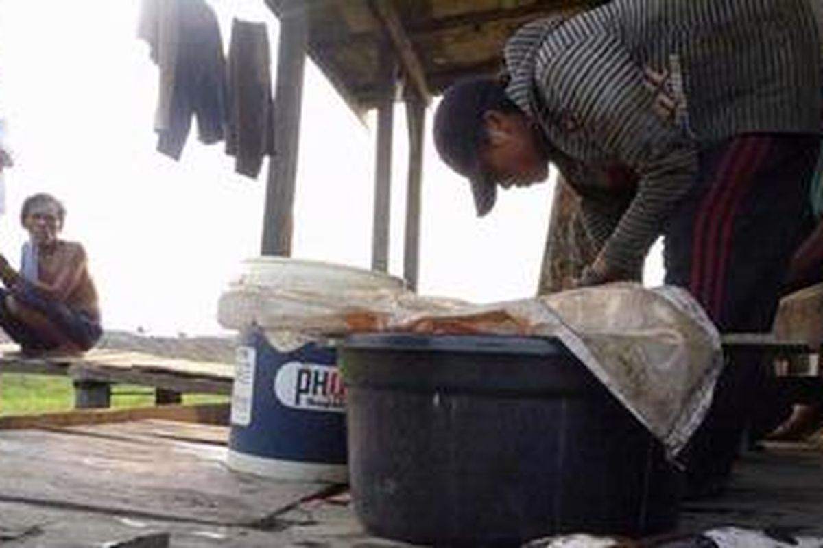 Suriansah (46) di depan rumahnya di Desa Sukakarya, Kecamatan Jenamas, Kabupaten Barito Selatan, Kalimantan Tengah.