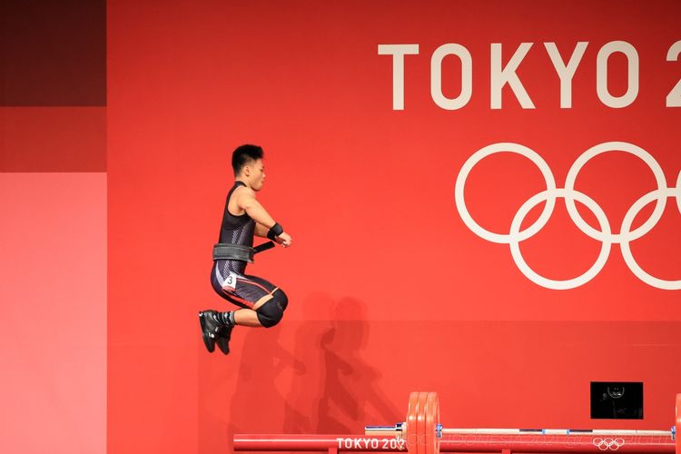 Aksi lifter Indonesia Rahmat Erwin Abdullah saat berlaga di cabor angkat besi Olimpiade Tokyo 2020. Rahmat Erwin berhasil meraih medali perunggu bagi Indonesia.