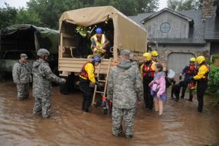 Tentara bekerja sama dengan organisasi penyelamatan lokal di Boulder County, Colorado, Amerika Serikat, bahu-membahu membantu para korban banjir bandang yang menerjang wilayah di jantung Amerika Serikat tersebut. Gambar diambil Jumat (13/9/2013).