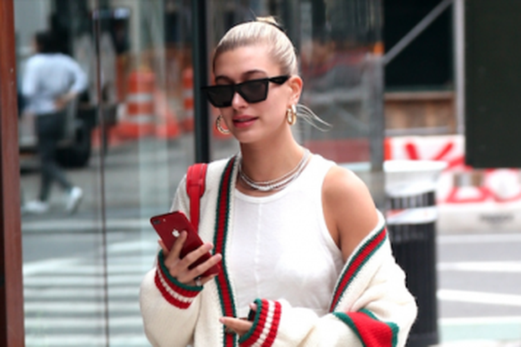 Hailey Baldwin in New York in a Gucci sweater and white Dr. Martens boots, May 22.