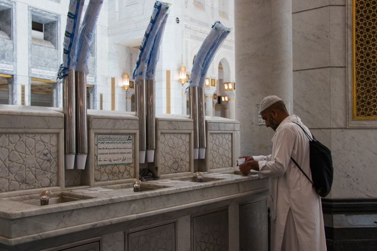 Seorang jemaah haji mengambil air zamzam di Masjidil Haram Mekkah