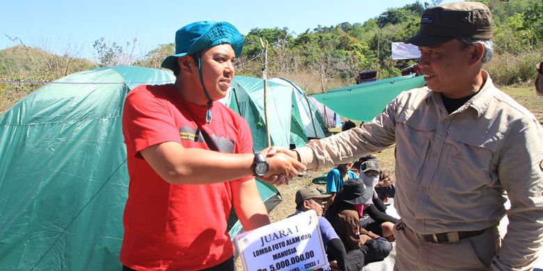 Kepala Balai Taman Nasional MataLawa Sumba, Maman Surahman (kanan) menyerahkan hadiah dan uang kepada juara I Kategori Alam dan Manusia pada kompetisi Lomba Foto Burung dan alam kepada Bayu Catur Pamungkas, Selasa (22/8/2017) di Resort Billa Kawasan TN MataLawa Sumba, Nusa Tenggara Timur. 