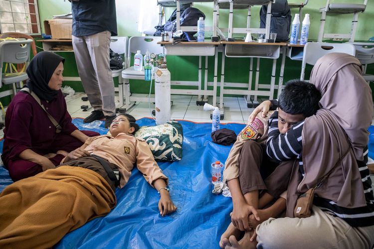 Orang tua mendampingi anaknya yang diduga keracunan hidangan makan bergizi gratis (MBG) di SMPN 1 Cisarua, Cisarua, Kabupaten Bandung Barat, Jawa Barat, Selasa (14/10/2025). Berdasarkan keterangan pihak sekolah, sebanyak 54 siswa mengalami keracunan yang diduga akibat menyantap hidangan makan bergizi gratis pada Selasa (14/10) pagi.